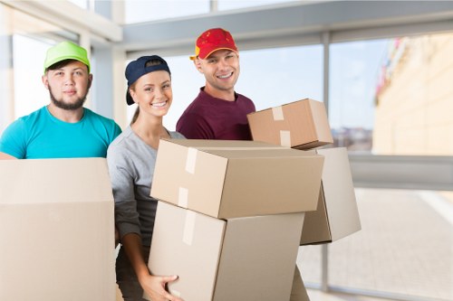 Professional packers organising boxes in a Tooting home before moving day