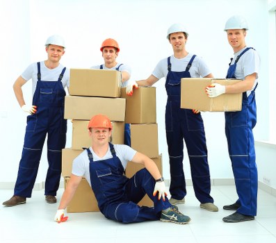 Packed boxes and furniture prepared for transport in a Tooting property