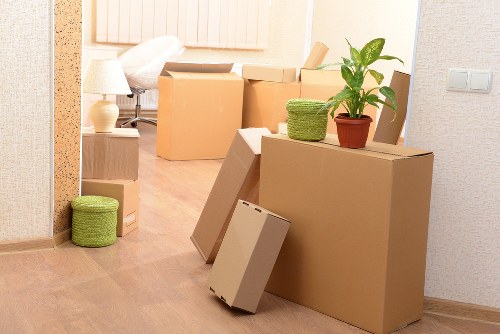 Movers carrying items down stairs in a Tooting flat
